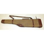 A canvas and leather leg o'mutton gun case by Manufrance, St Etienne, 85cm long and an army great