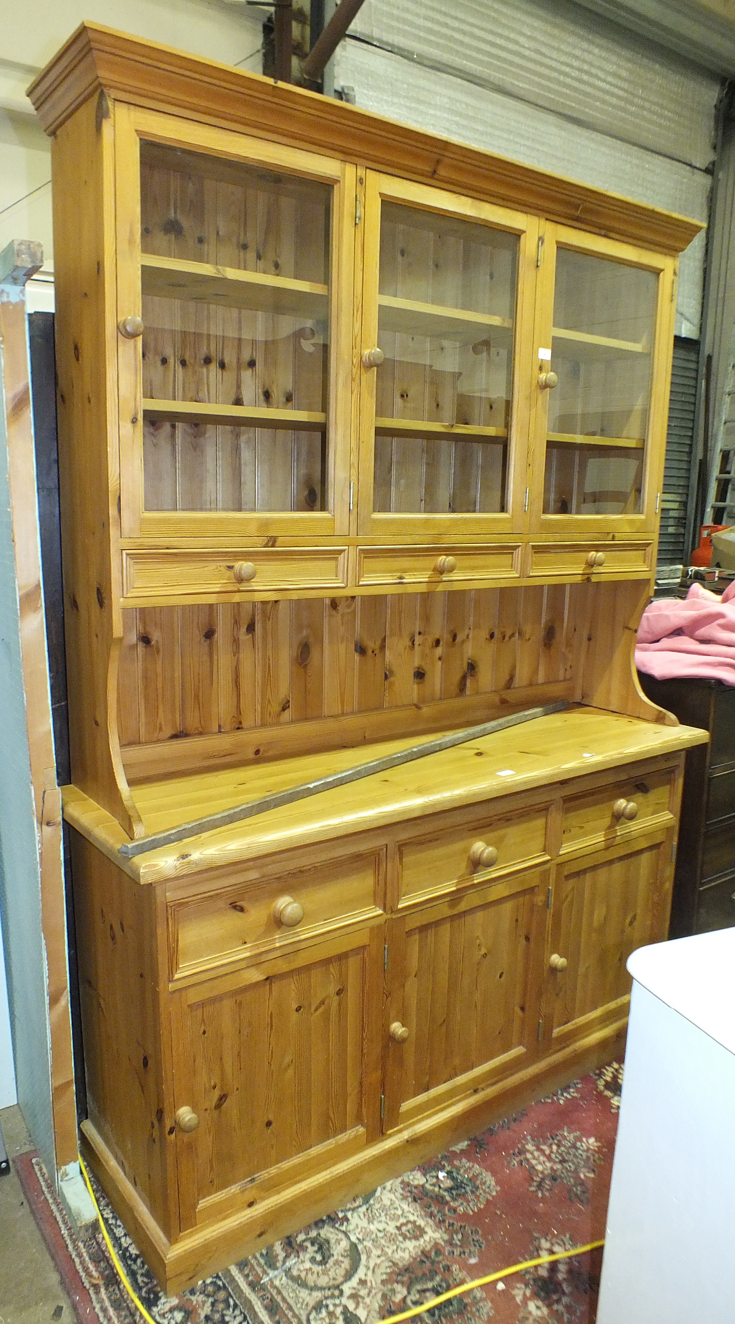 A modern pine kitchen dresser, with glazed doors above drawers and cupboards, 150cm wide, 214cm