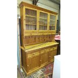 A modern pine kitchen dresser, with glazed doors above drawers and cupboards, 150cm wide, 214cm