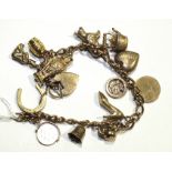 A 9ct gold bracelet of curb links, with thirteen charms and padlock clasp, 29g.