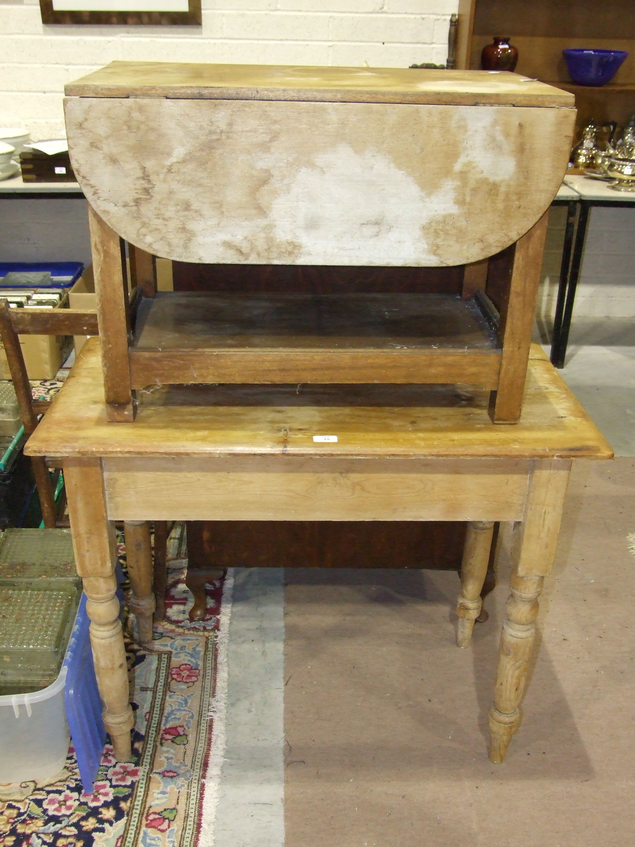 A pine table, the rectangular top above an end drawer, on turned legs, 50 x 94cm, a small drop-