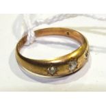 An 18ct gold gypsy ring set three brilliant-cut diamonds, size L, 2.9g.