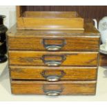 A table-top stained wood nest of four drawers, 33.5cm wide, 25cm high, 26cm deep and a wooden