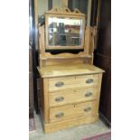 An early-20th century satin walnut dressing chest, the mirrored support above three long drawers,