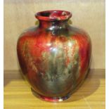 A Royal Doulton flambé vase of ovoid shape decorated with mottled glazes over a red ground,