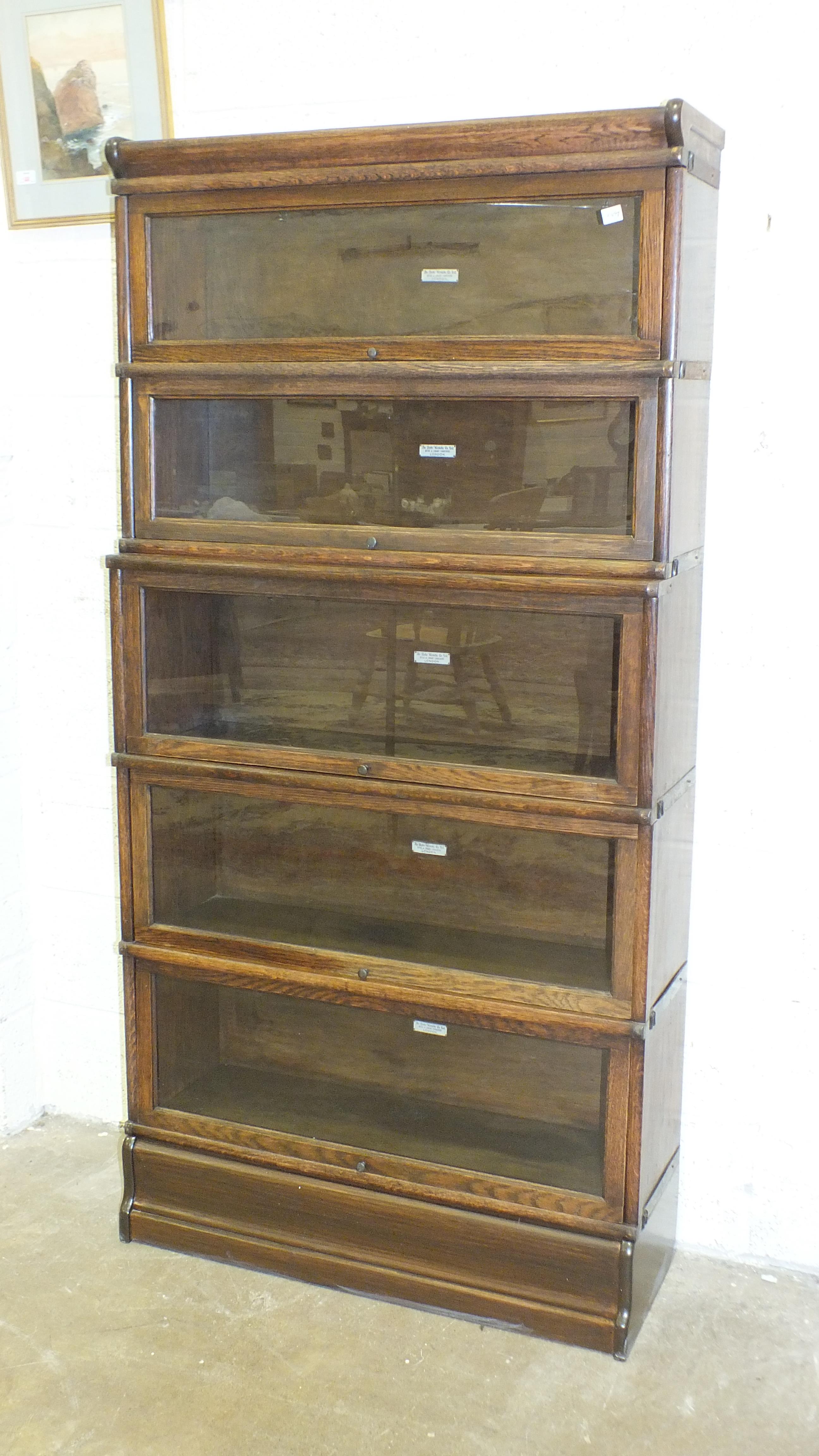 A Globe Wernicke five-tier oak sectional bookcase on base, each section with factory label, 175cm