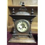 A stained wood-cased mantel clock of architectural form, with Jurgens gong-striking movement, 42cm