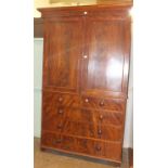 An early-19th century mahogany linen press, the pair of panelled doors enclosing three shelves,