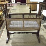 An early-19th century mahogany Bergère caned cradle, on turned stand, cradle 91 x 46cm, 113cm high