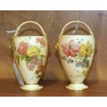 Two Royal Worcester posy baskets with painted floral decoration and gilt lion masks, on blush