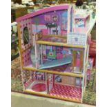 A Kid Kraft three-storey doll's house with elevator, a boxed Barbie Dream Cottage and three cars, (