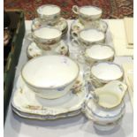 Twenty-eight pieces of a late-19th century tea service decorated with flowers and gilt rims, (one