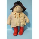 A 1980 Film Fair Paddington Bear, with felt hat and duffle coat, (faded) and red wellies, 50cm.