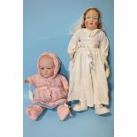A Heubach Köppelsdorf 348 bisque-head baby doll, on stuffed body, 32cm and an Aronstein bride doll