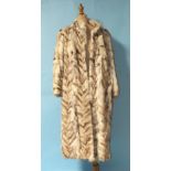 A full-length fur coat of chevron design.