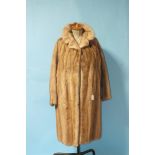 A blonde mink coat, full-length, size 14, no furrier's label.