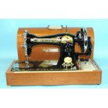 A cased manual sewing machine by 'The Normann Sewing Machine Company'.