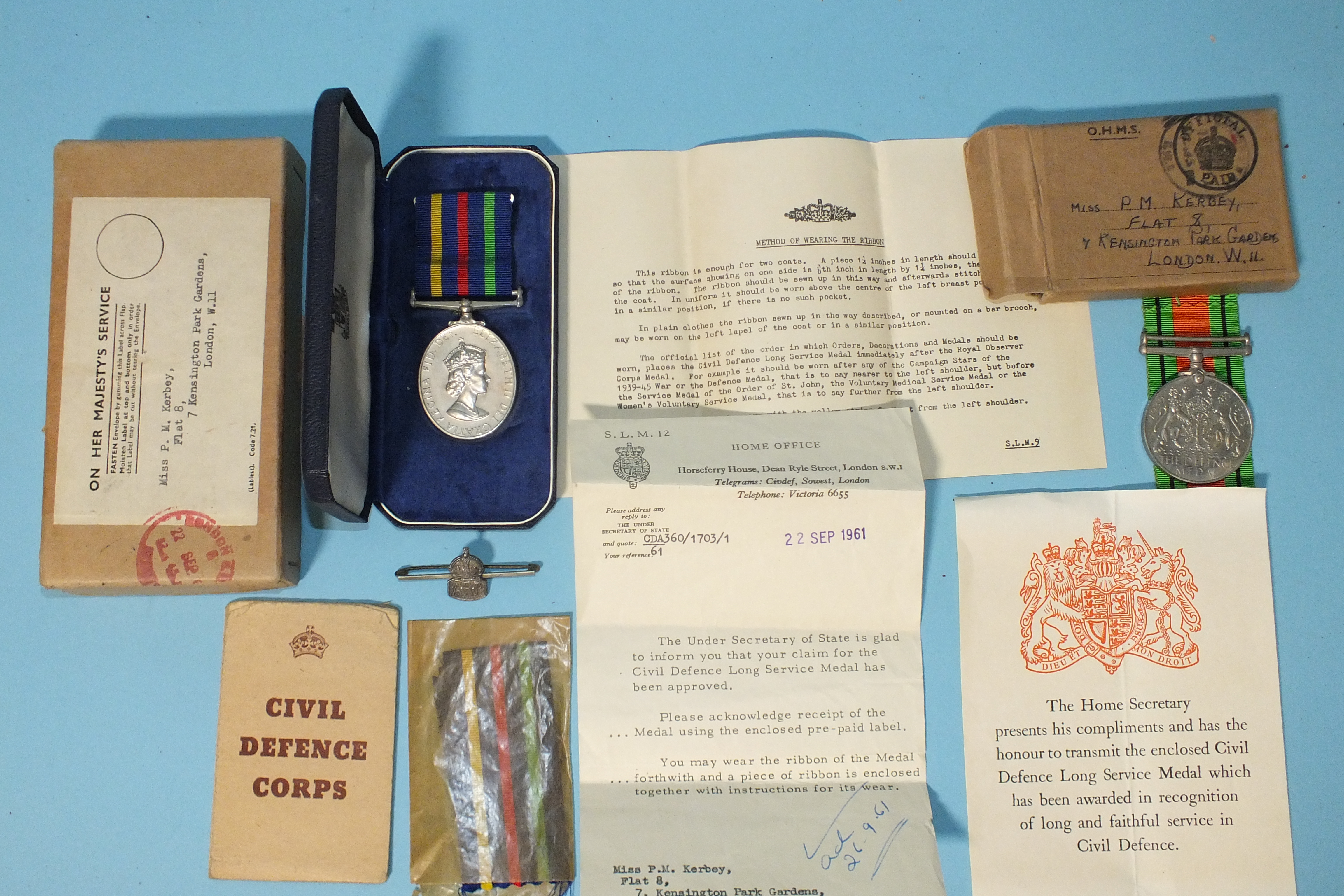 A WWII Defence Medal and an ERII Civil Defence Long Service Medal, boxed with papers, awarded to