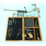 A boxed set of fly-tying equipment and a large brass & metal tying vice.