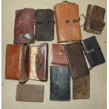 A large late-19th century leather folding cast wallet retained by original strap, another with green