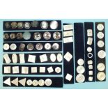 A collection of sixty-four mother of pearl and abalone buttons of various shapes and sizes mounted