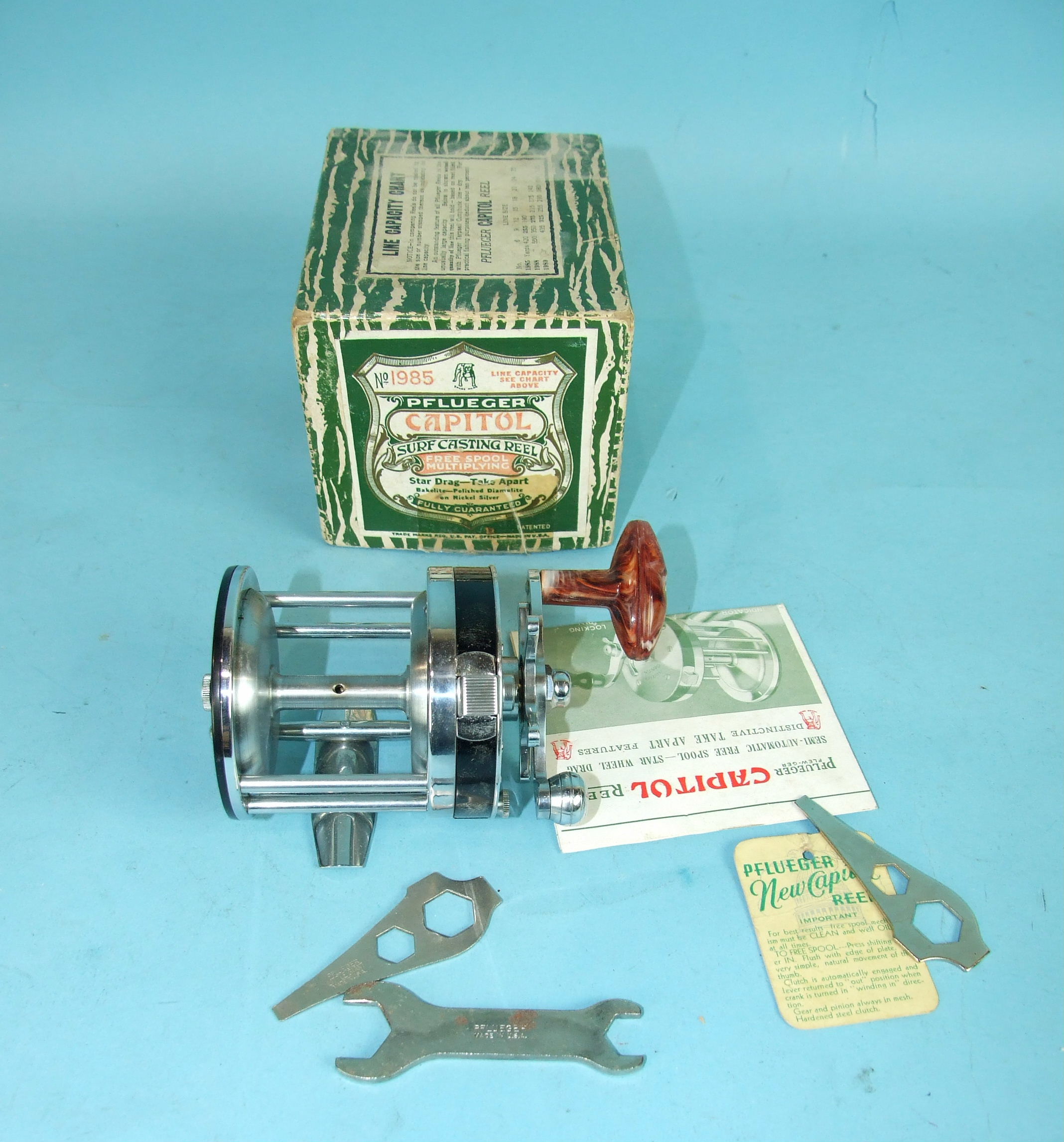 A Pflueger Capitol No.1985 Surf casting reel with spanners and instructions, boxed.