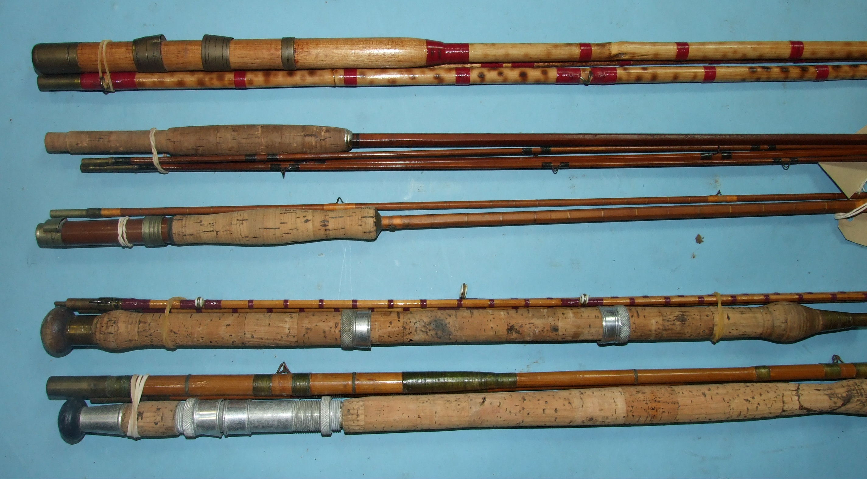 A burnt bamboo 10ft 6-inch 3-piece fly rod with greenheart tip, a 3-piece split-cane rod with