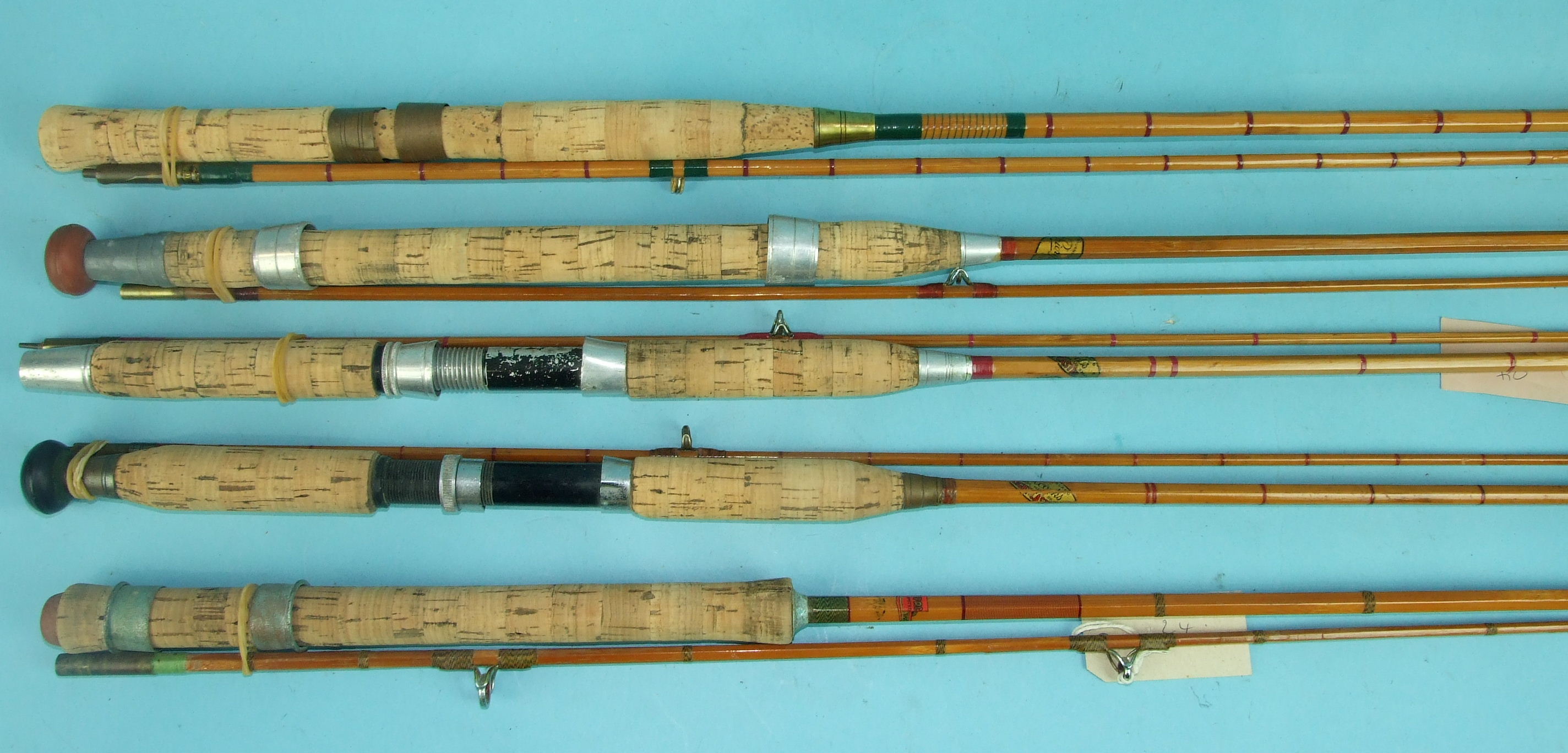 Two Allcocks 2-piece split-cane spinning rods, a PAC Ltd 2-piece SC spinning rod and two others, (