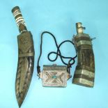 A metal and bone-handled kukri knife in metal-mounted scabbard, a horn and metal-mounted powder