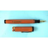 An unmarked fountain pen with orange barrel and cap, the nib stamped Watermans Ideal Pens 18k 750