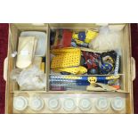 A large quantity of Meccano, mainly blue and yellow, including one clockwork and two electric