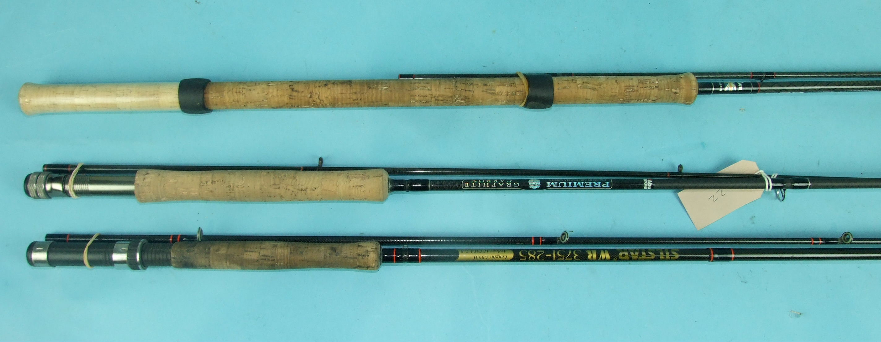 An Abu-Garcia Premium graphite carbon 9ft 6-inch 2-piece fly rod, a Silstar WR3751-285, 2.85m 2-