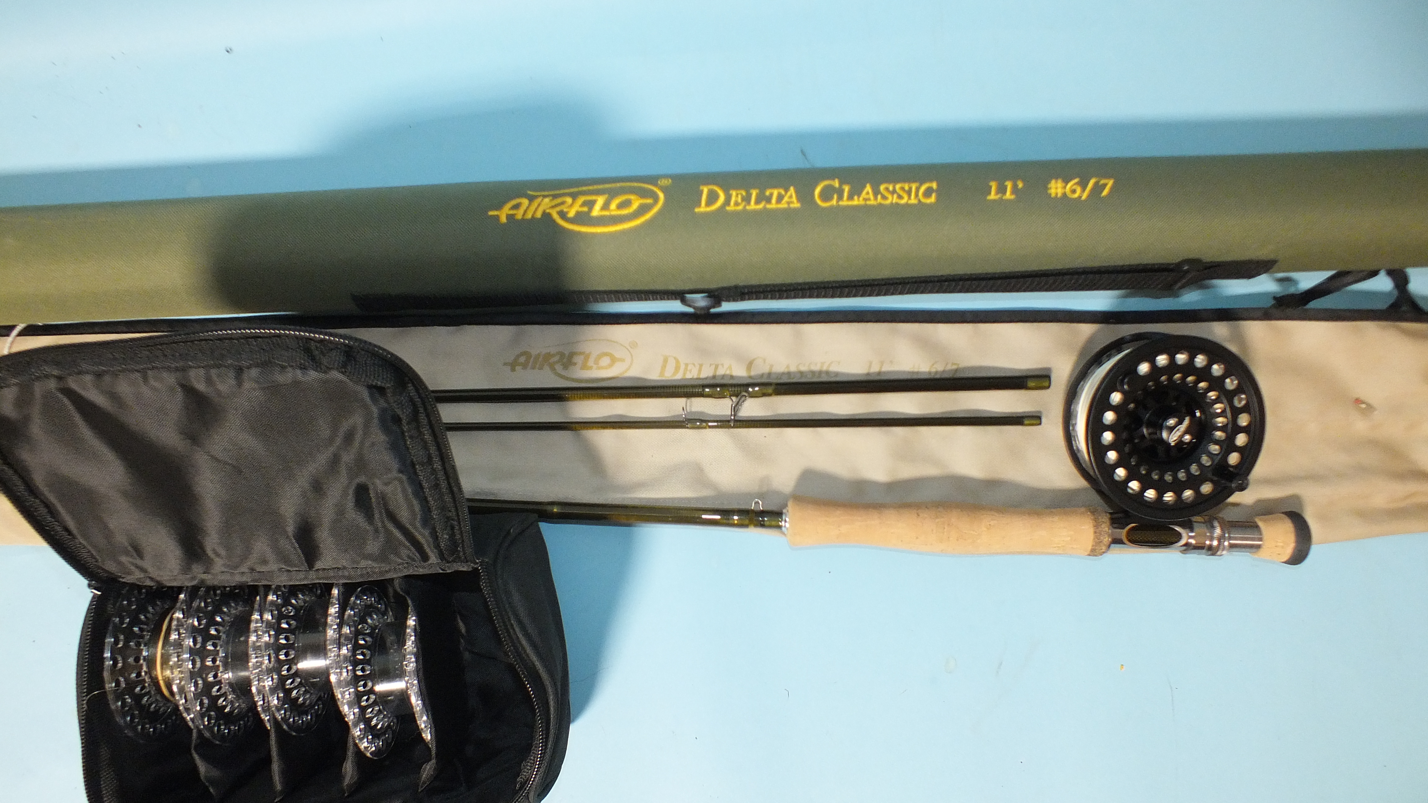 An Airflo delta Classic 11ft #6/7 graphite 3-piece fly rod in bag and tube, together with an