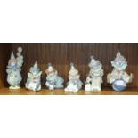 A collection of six unboxed Lladro clown figures, including playing a concertina, holding