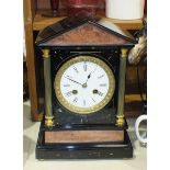 A black slate and marble striking mantel clock of architectural design, with brass pillars, 29.5cm