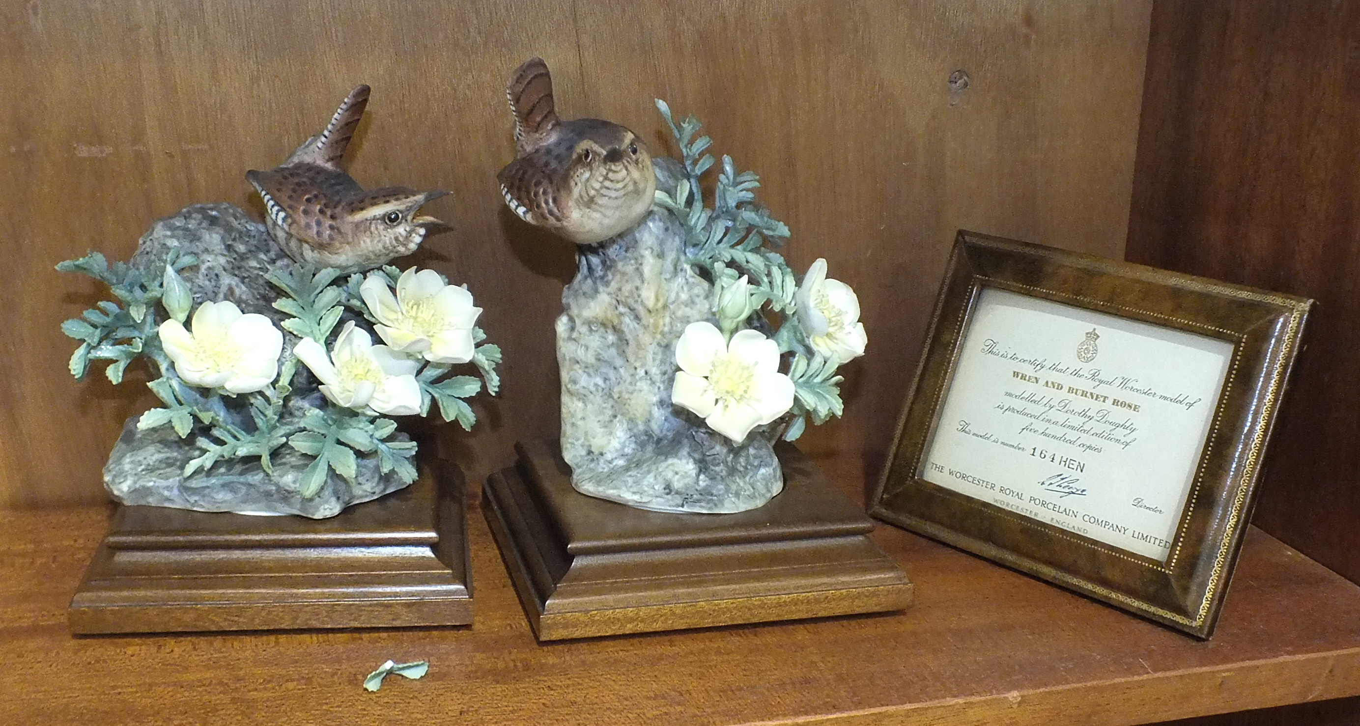A pair of Royal Worcester bird models, 'Wren and Burnett Rose', (Hen and Cock), by Dorothy