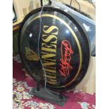 A Guinness oval plastic illuminated advertising sign with wall-mounting bracket, a large quantity of