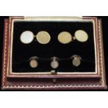 A set of engine-turned 9ct gold dress studs, cased, 9.8g.