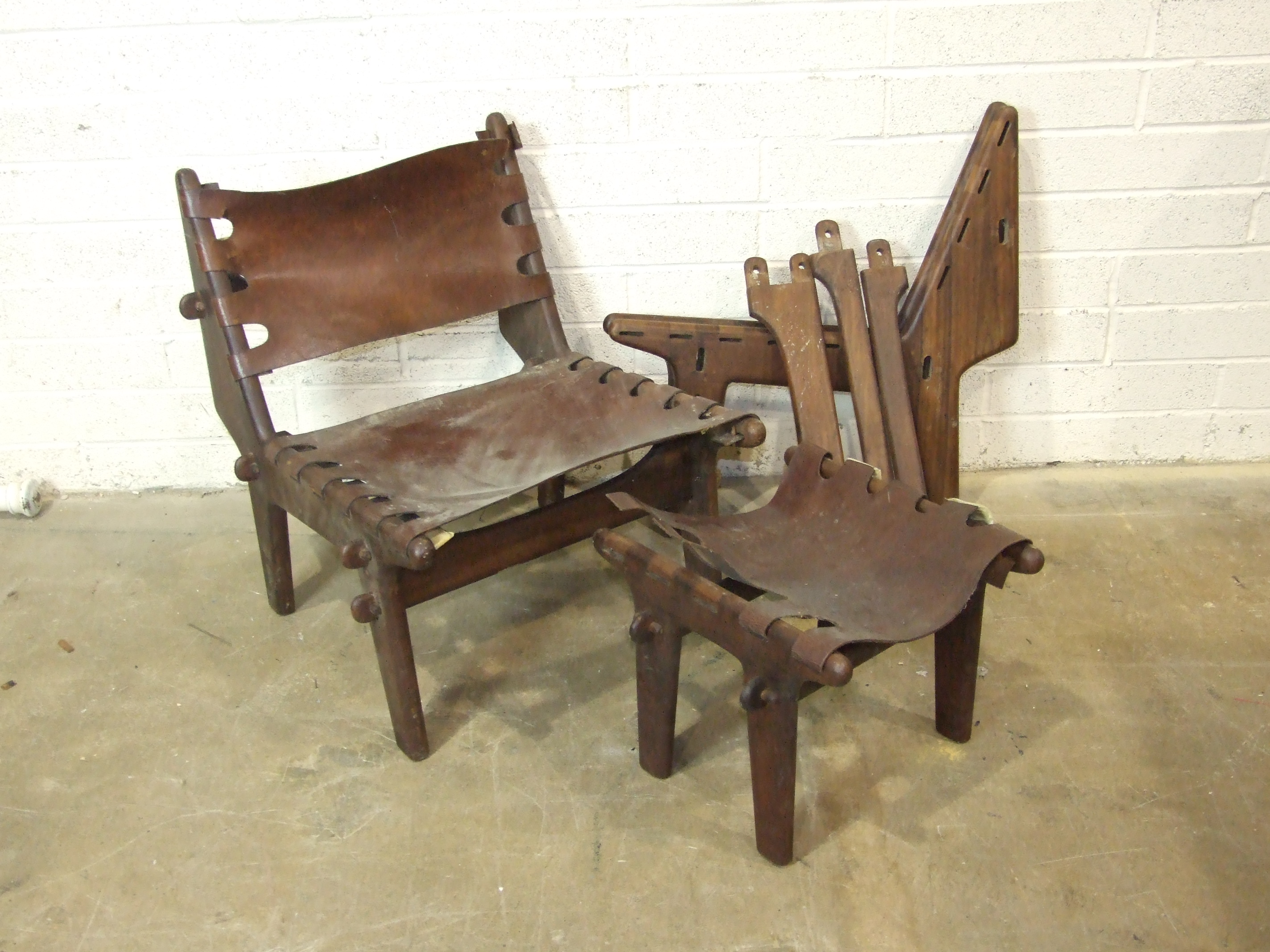 A mid-20th century South American hardwood low chair with leather back and seat, a similar chair - Image 2 of 3