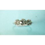 A three-stone diamond ring, the old brilliant-cut diamonds claw-set in platinum, (marks rubbed),