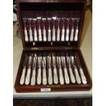 A set of twelve each mother-of-pearl-handled plated dessert knives and forks, in mahogany fitted