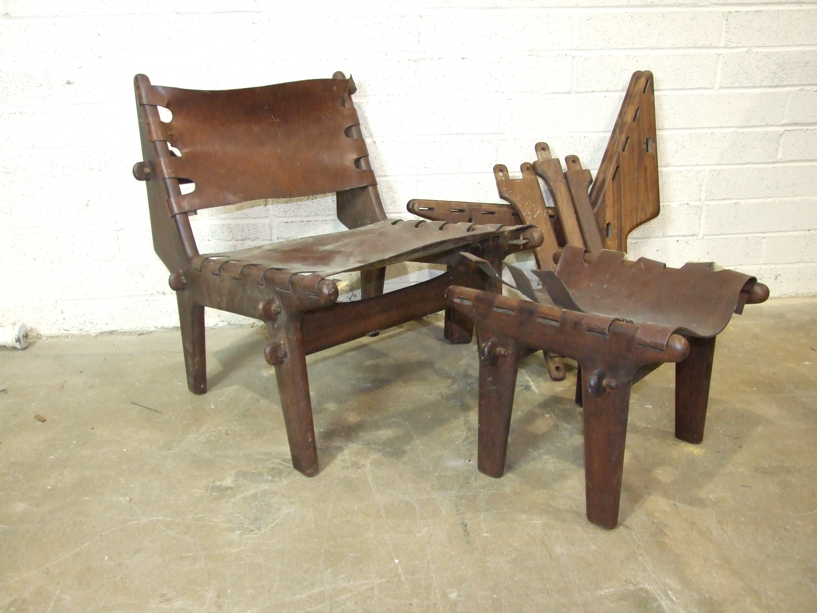 A mid-20th century South American hardwood low chair with leather back and seat, a similar chair