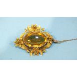 A Victorian gold brooch set a large oval citrine, in ornate floral mount, unmarked, (tested as