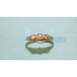 A three-stone diamond ring, the brilliant-cut diamonds illusion-set in 18ct gold mount, size L, 2.
