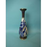 A Doulton ceramic baluster vase decorated with gilt and underglaze blue iris, 28cm high.