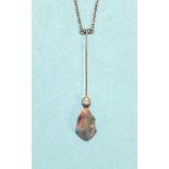 An Edwardian black opal and diamond necklace claw-set a pear-drop opal, below a millegrain-set