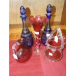 A pair of 20th century blue overlay glass decanters with stoppers, 27cm high, a cranberry glass