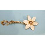 A yellow gold and enamel flower brooch with six white enamelled petals about a diamond centre, 49mm,