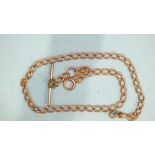 A 9ct rose gold curb-link watch chain with metal T-bar and shackle, gross weight 29.5g.
