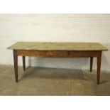A chestnut and fruit wood early-19th century kitchen table, the top formed of two planks above a